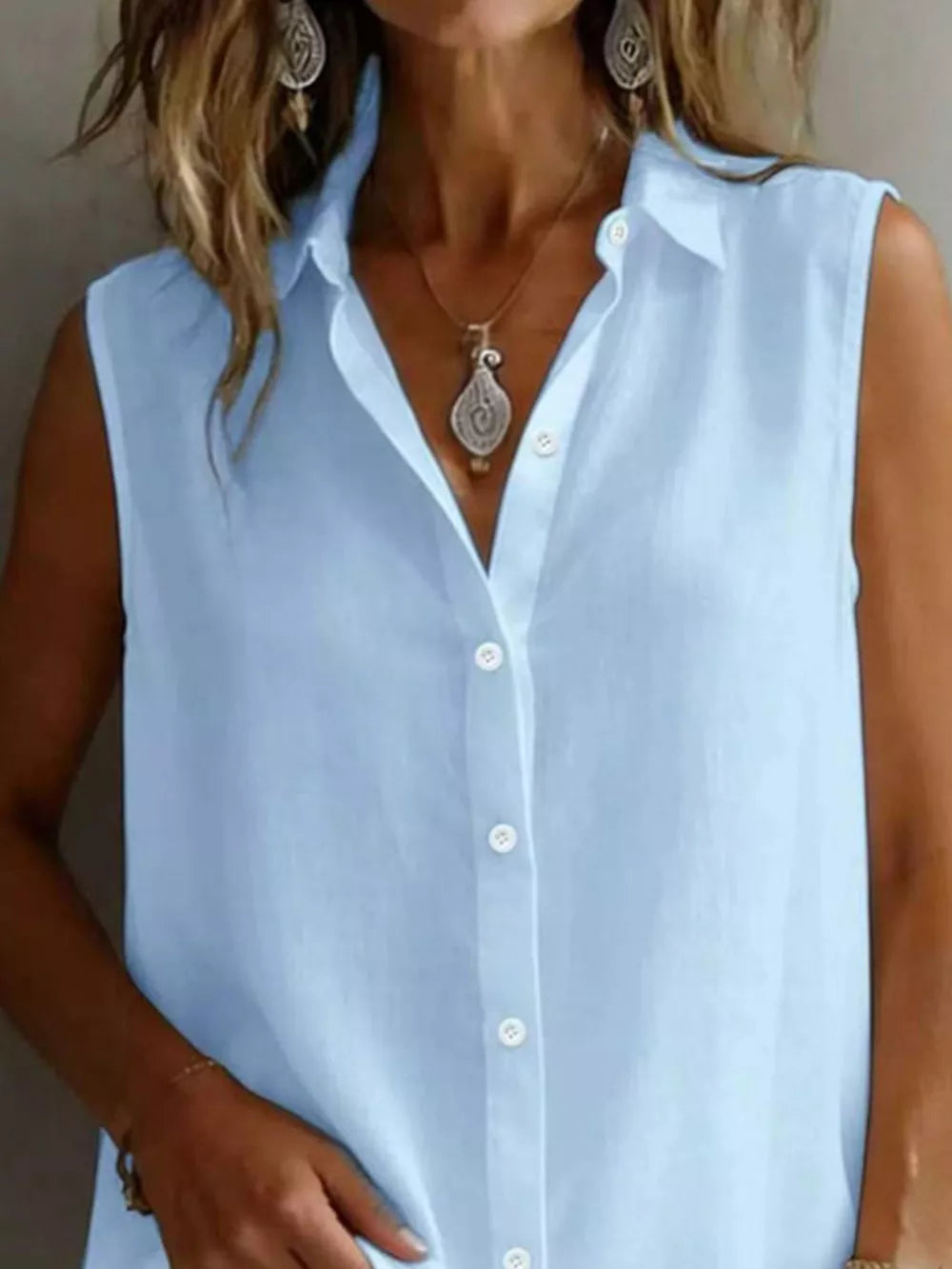 Light blue sleeveless button-up shirt with a collared neckline.