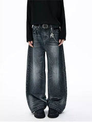 Belted dark-wash wide-leg jeans with unique paneled design and chain detail.