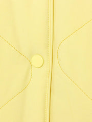 Yellow quilted puffer jacket with snap button detail and contrast stitching.