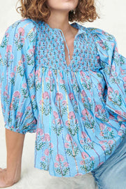 Sky blue floral print smocked yoke blouse with puff sleeves and tie neck