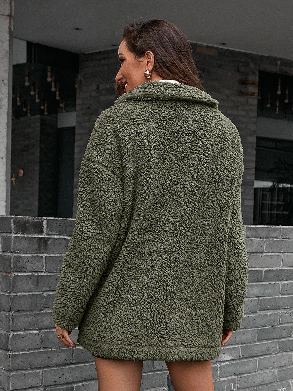 Green asymmetrical teddy moto jacket with a collared neckline and plush texture.