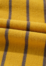 Yellow knit sweater with dark grey vertical stripes, close-up texture detail.