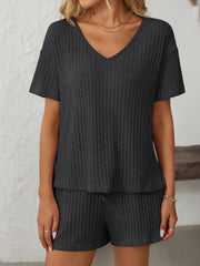Black ribbed V-neck loungewear set with short sleeves and drawstring shorts.