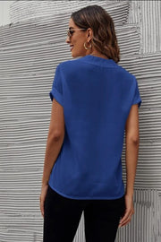 Royal blue blouse with cuffed short sleeves and a V-neckline, shown from the back.