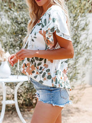 White floral print v-neck blouse with tie detail and flutter sleeves
