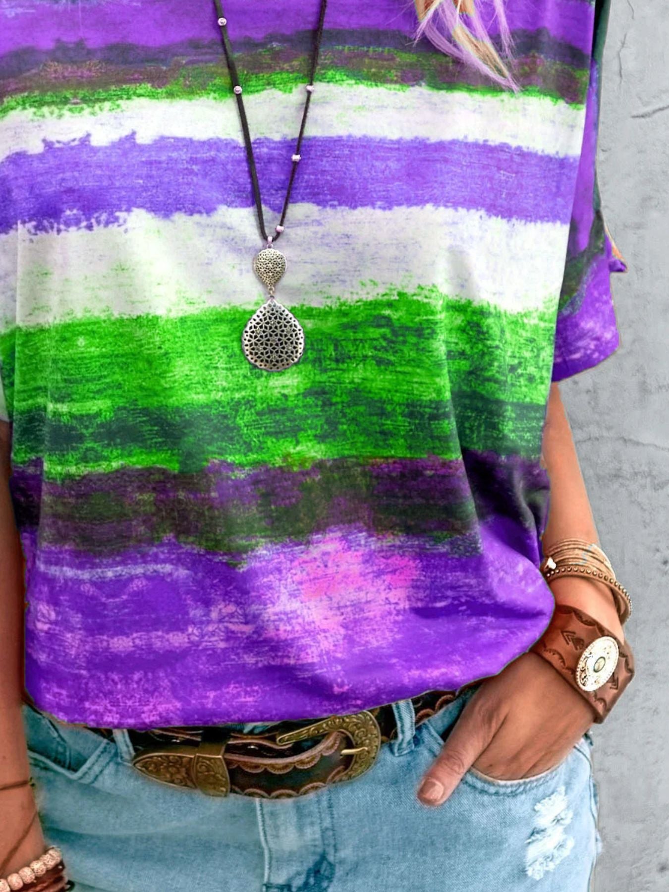 Casual t-shirt with brushstroke stripes in purple, green, and white.