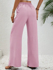 Pink textured palazzo trousers with drawstring waist and wide leg