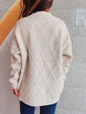 Beige relaxed fit sweater with diamond cable knit pattern and crew neck.