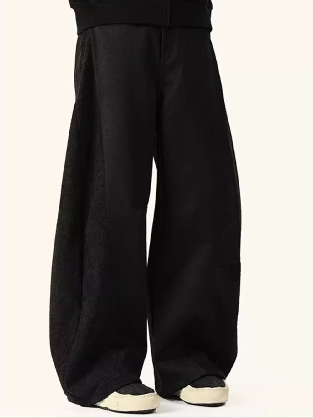 Black relaxed fit sweatpants with contrast textured panels.
