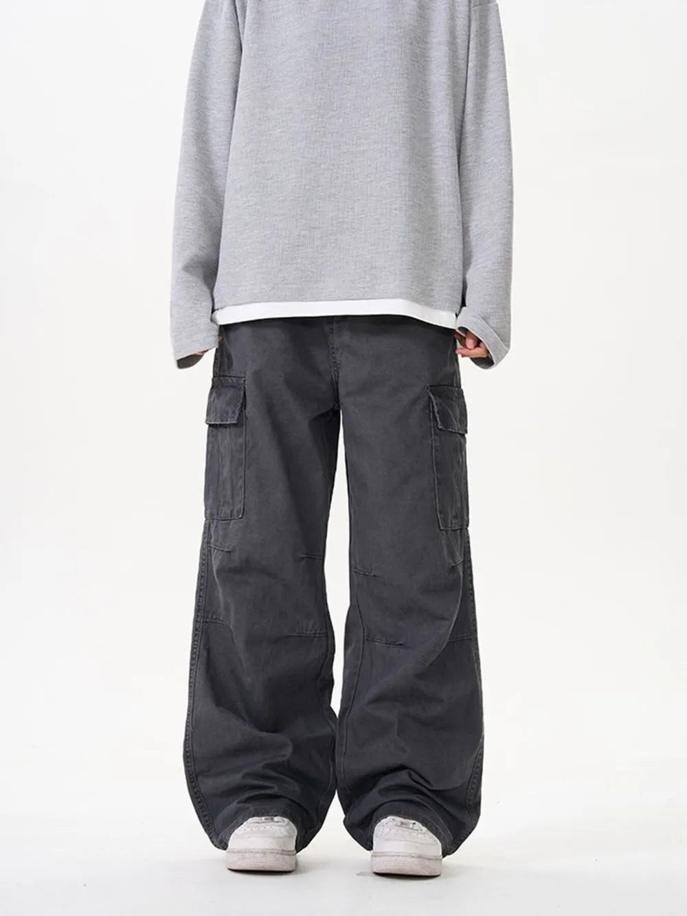 Grey cargo pants with versatile pockets and a relaxed fit.