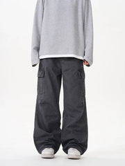 Grey cargo pants with versatile pockets and a relaxed fit.