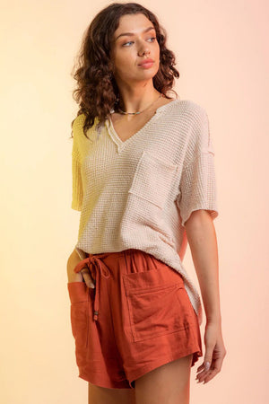Relaxed waffle knit v-neck top in Sand with a chest pocket and short sleeves.
