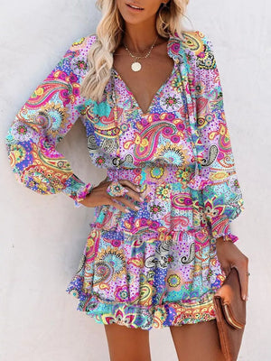 Abstract paisley tiered mini dress with ruffles and a v-neck in a multicolor print.