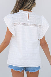 White eyelet yoke blouse with ruffle sleeves and a lace inset detail.