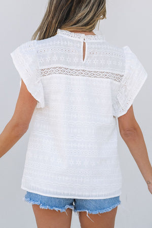 White eyelet yoke blouse with ruffle sleeves and a lace inset detail.