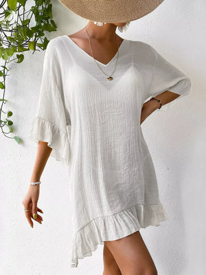 White ruffled V-neck cover-up dress with bell sleeves and a textured acrylic fabric.