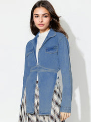 Medium wash denim wrap jacket with tie waist and asymmetric hem.