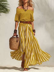 Yellow off-shoulder top and striped maxi skirt set with a brown belt.