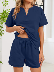 Navy blue loungewear shorts with drawstring waist and cuffed hem.