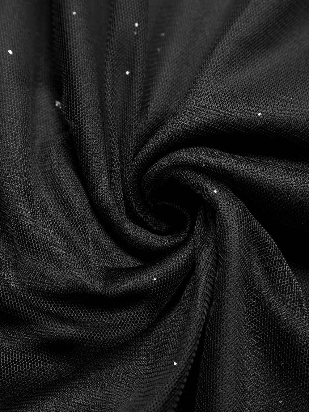 Black glitter tulle fabric detail, showing sheer mesh with scattered sparkle accents.