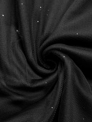 Black glitter tulle fabric detail, showing sheer mesh with scattered sparkle accents.
