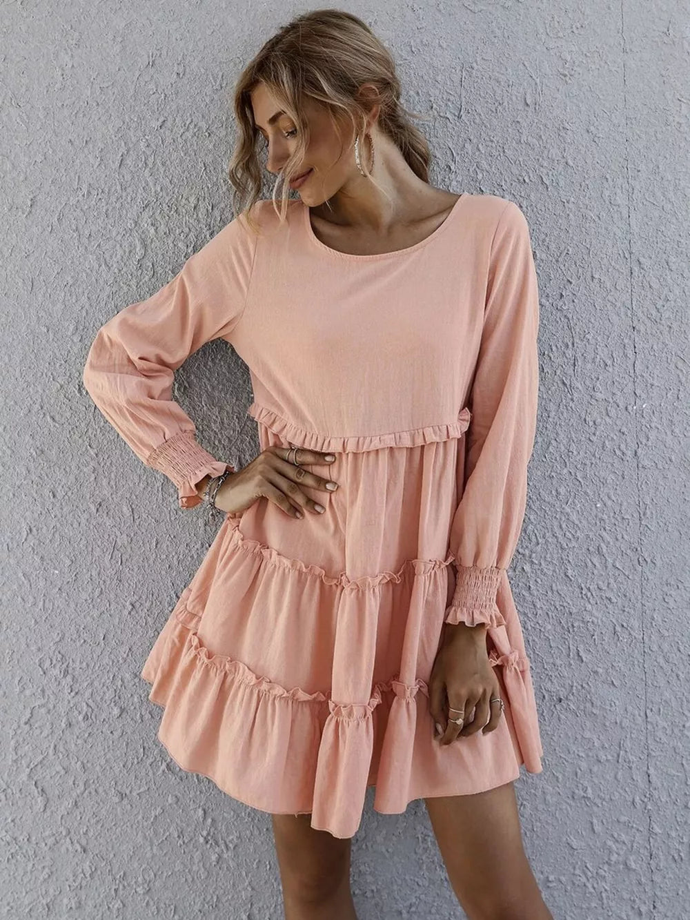 Apricot ruffled mini dress with long sleeves and tiered skirt