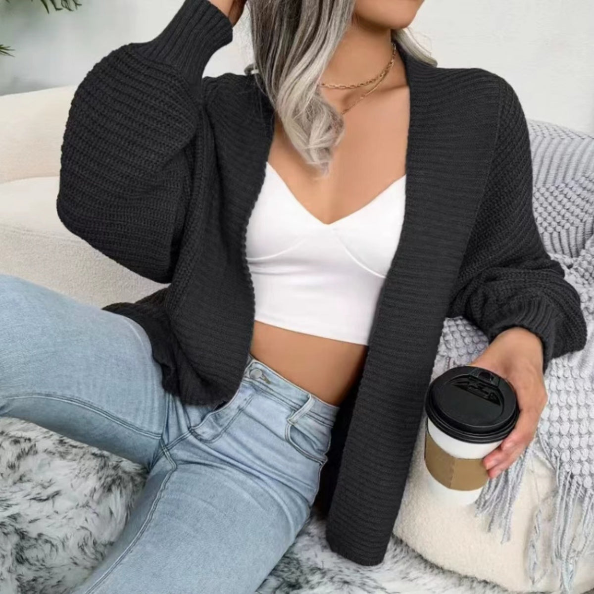 Black chunky knit dolman sleeve cardigan with ribbed cuffs and open front.