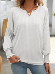 White textured blouson top with v-neck and ruched blouson sleeves.