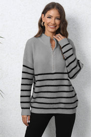 Striped ribbed knit quarter-zip sweater in gray with black stripes and a mock neck.