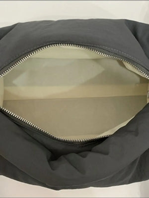 Dark gray padded knot shoulder bag with silver zipper detail