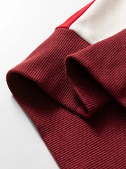 Vibrant color block cotton hoodie sleeve detail in burgundy with red and cream accents.