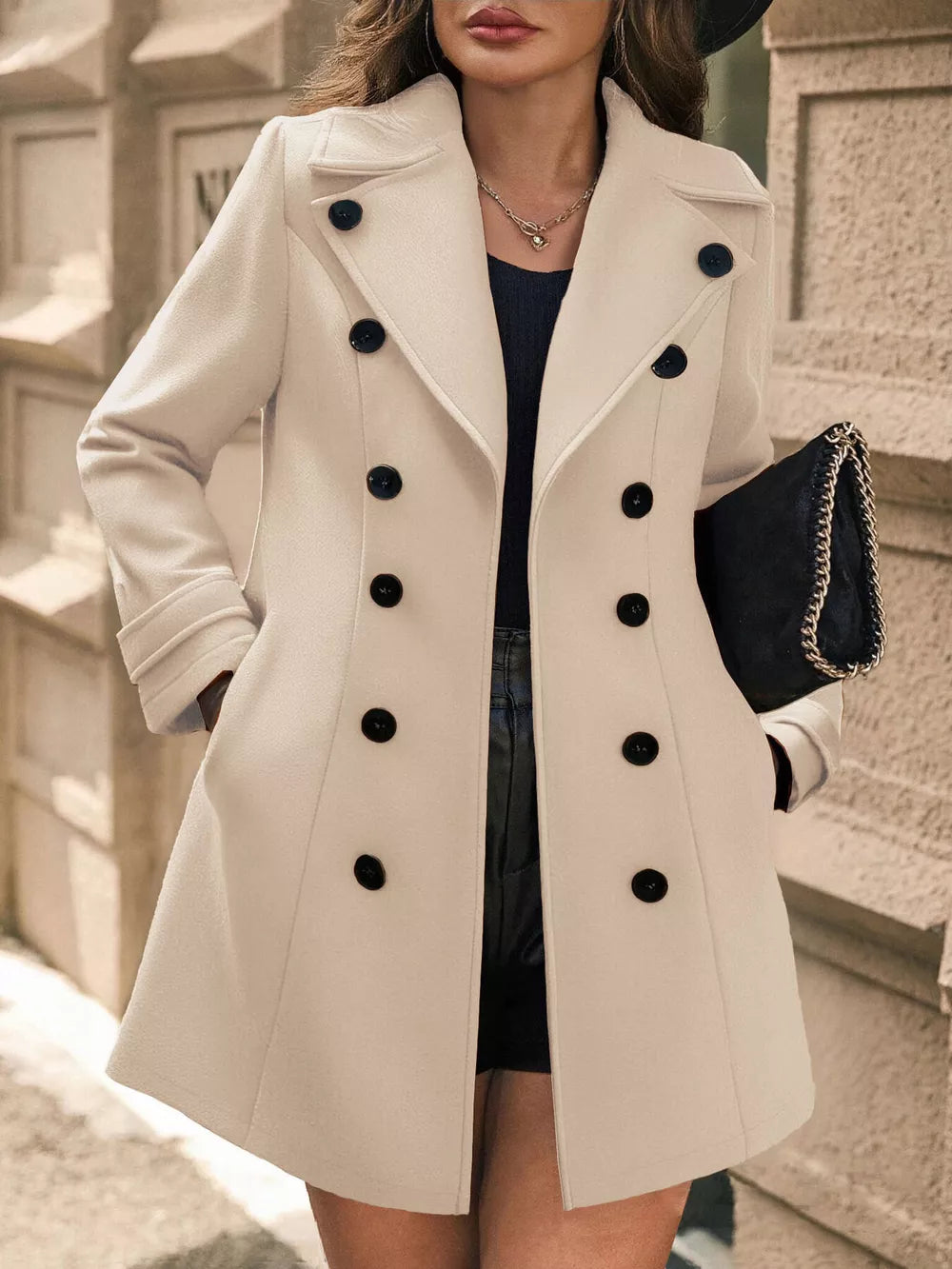 Pale blush double-breasted wool blend trench coat with black buttons and cuffed sleeves.