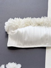 White bandeau bikini top with textured fabric and ruffle trim detail