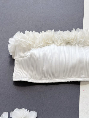 White bandeau bikini top with textured fabric and ruffle trim detail