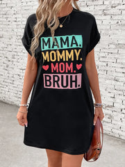 Black graphic tee dress with Mama Mommy Mom Bruh text, cuffed sleeves, and crew neck.