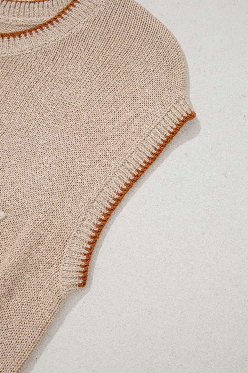 Howdy Textured Knit Sweater Vest in beige acrylic with contrast trim and a ribbed neckline.
