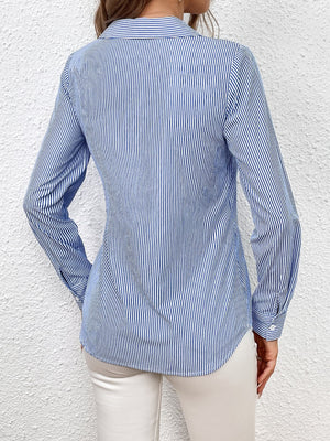 Sky blue and white striped wrap-front blouse with bow detail.