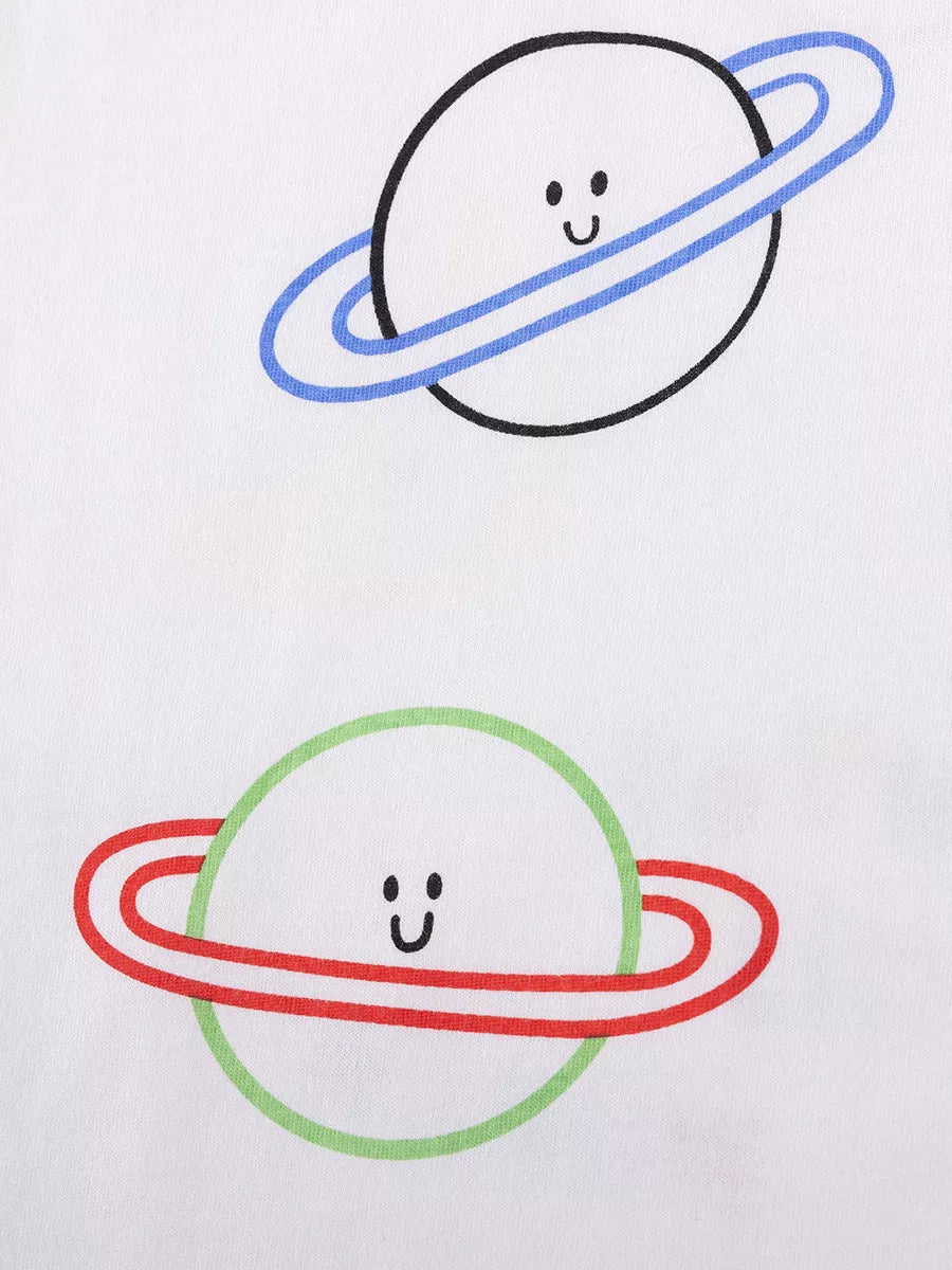 Children's white tee with smiling planet print and blue and red rings.