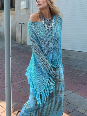 Sky blue open-knit acrylic boat neck poncho with fringe trim and boat neck.