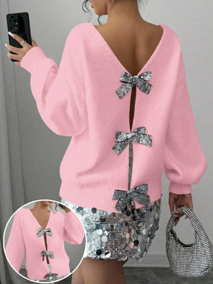 Pink knit cardigan with sequin bow details and V-neck.