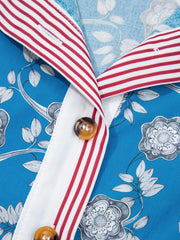Blue cotton blouse with botanical print, white placket, and red striped collar.