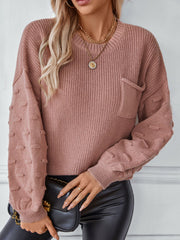 Dusty pink knit sweater with textured sleeve details and a chest pocket.