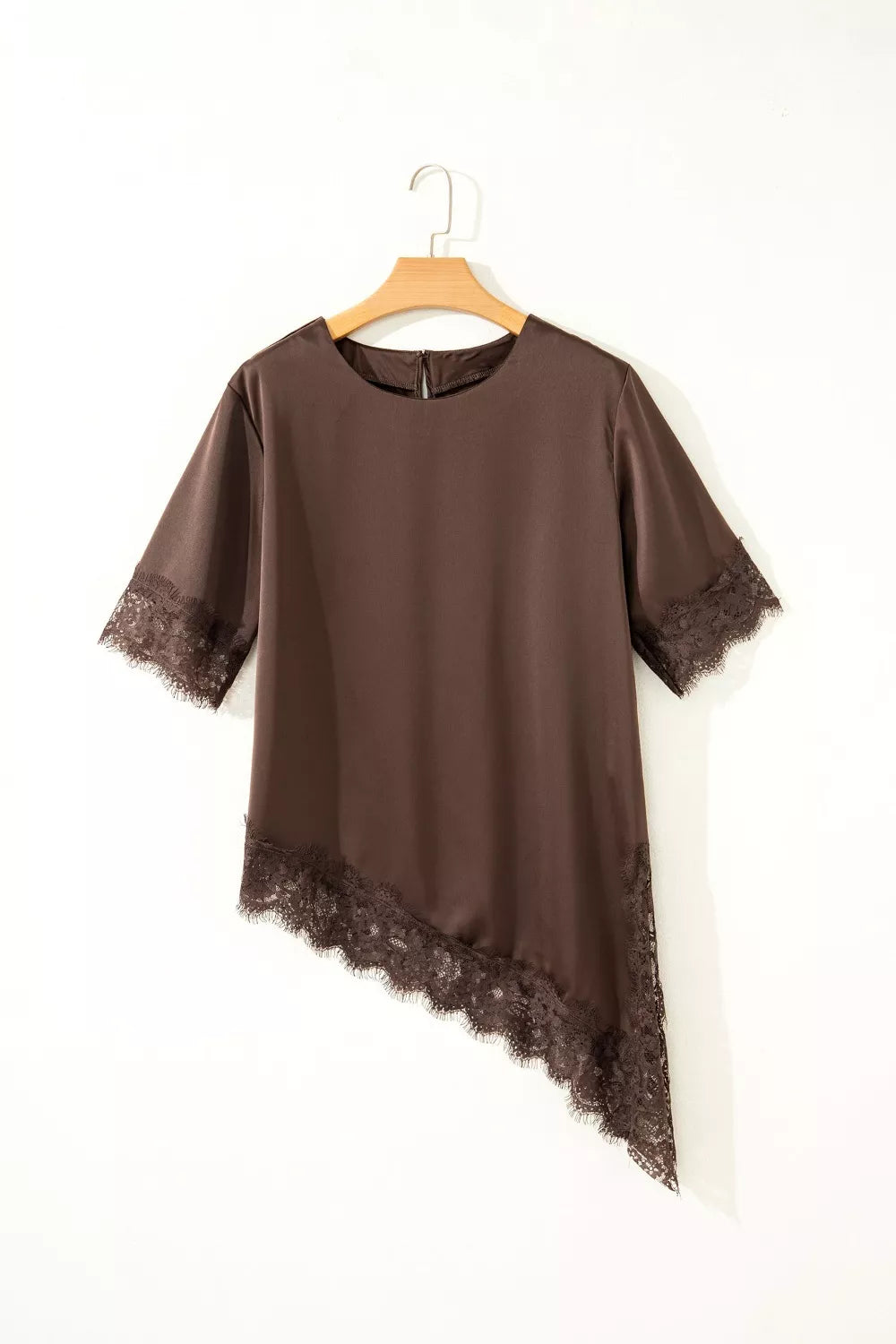 Brown asymmetric satin maternity blouse with lace trim details.