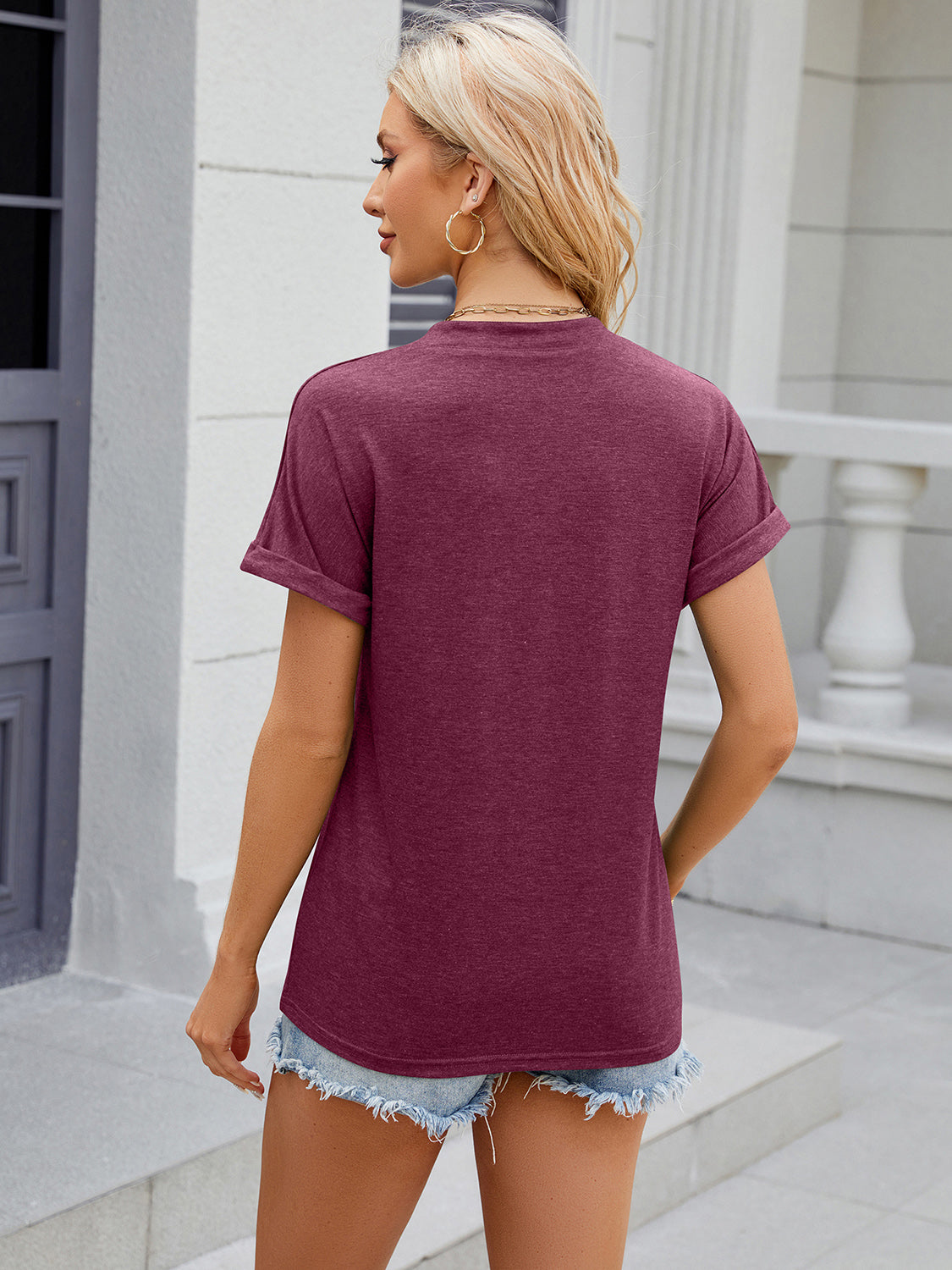 Burgundy t-shirt with rolled cuff sleeves and crew neck, casual style.