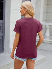 Burgundy t-shirt with rolled cuff sleeves and crew neck, casual style.