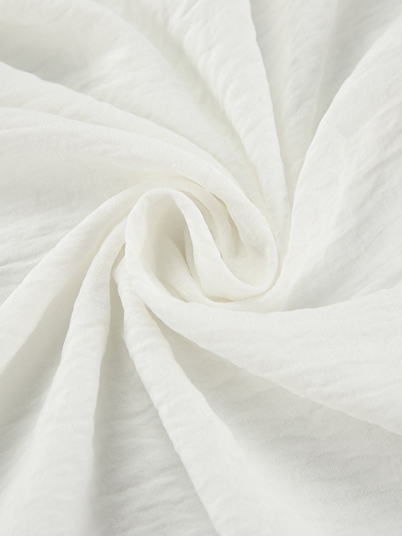 White off-shoulder midi dress fabric detail with textured crinkle weave