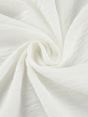 White off-shoulder midi dress fabric detail with textured crinkle weave