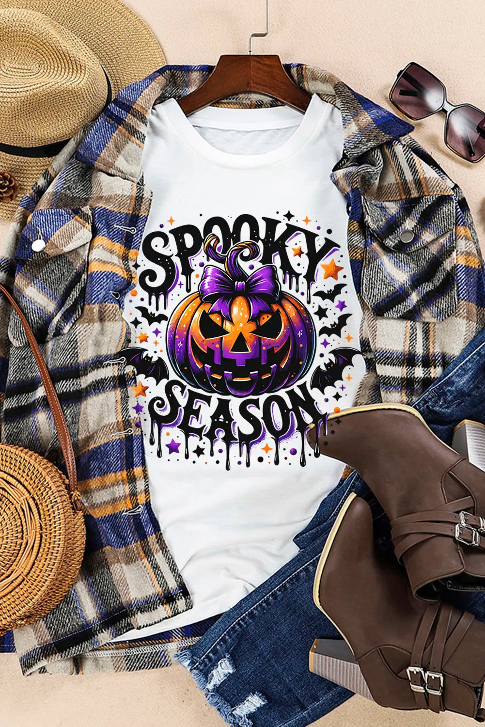 White oversized tee with spooky pumpkin and bat print for Halloween season.