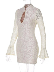 White lace cutout mini dress with flared sleeves and high neckline.