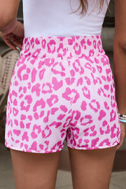 Pink leopard print shorts with elastic waistband and scalloped hem